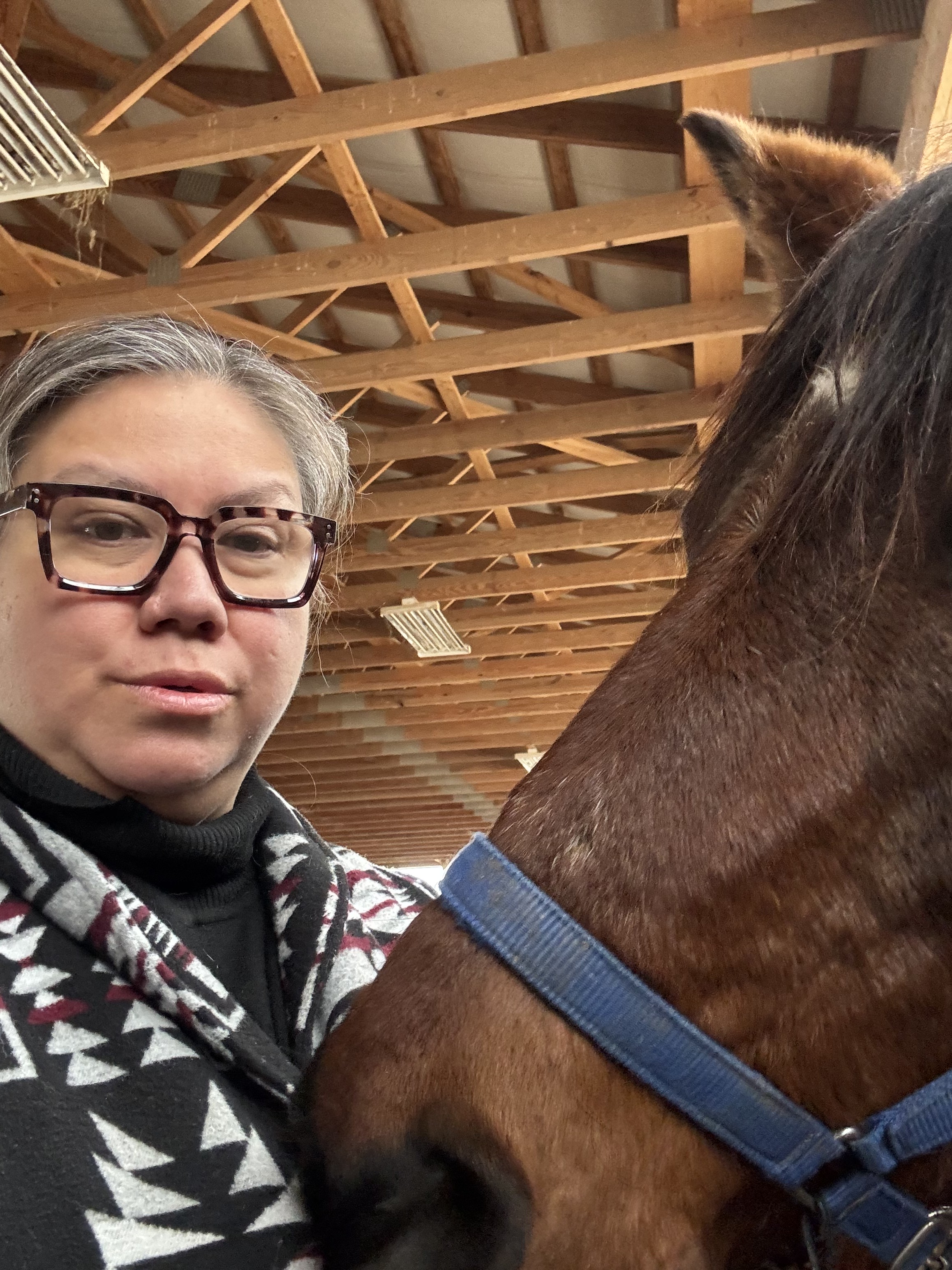 Charity Kennedy with a horse at Manidoo Wellness Ranch